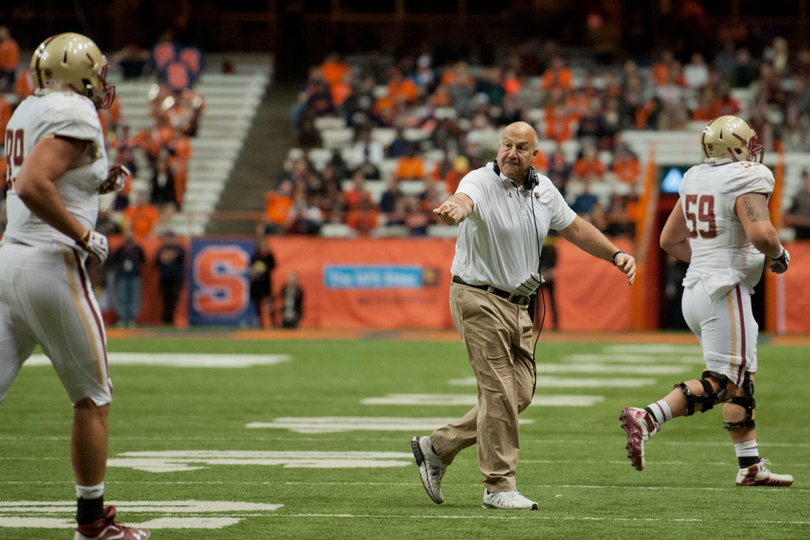 Eagles head coach Steve Addazio beckons for his player's attention as he jogs off of the field. 