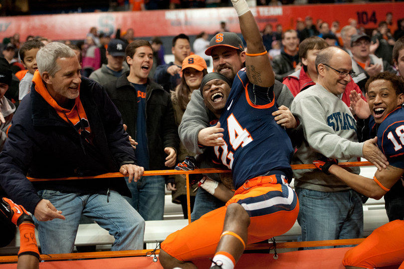Cornerback Jaston George and wide receiver Christopher Clark celebrate with fans after the win. 