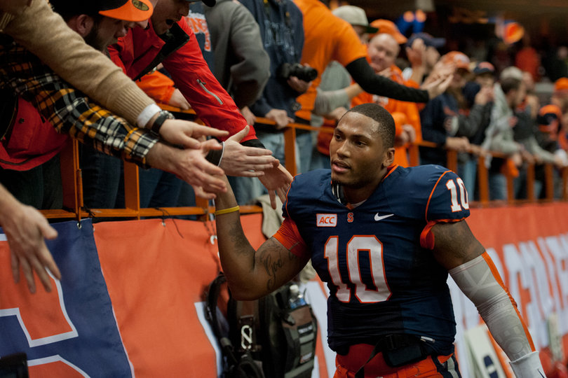 Hunt runs through a line of high fives after leading SU to a touchdown in the team's final drive. 