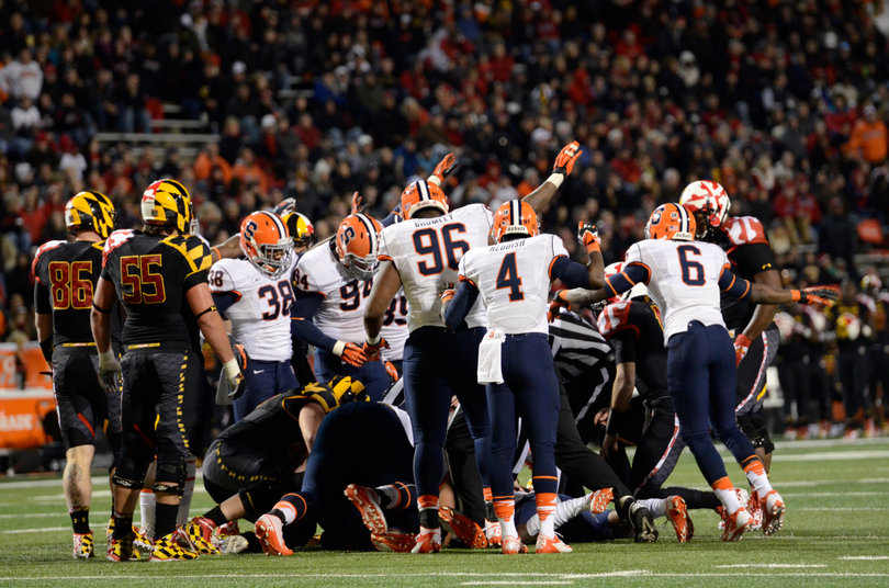 Syracuse players all signal that the ball is theirs after a fumble. 