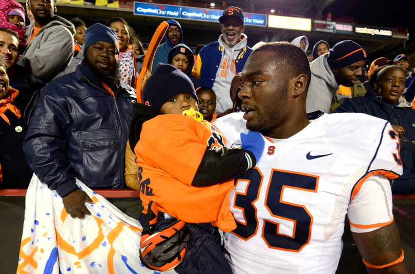 Dyshawn Davis celebrates with family after Syracuse's 17-point win. 