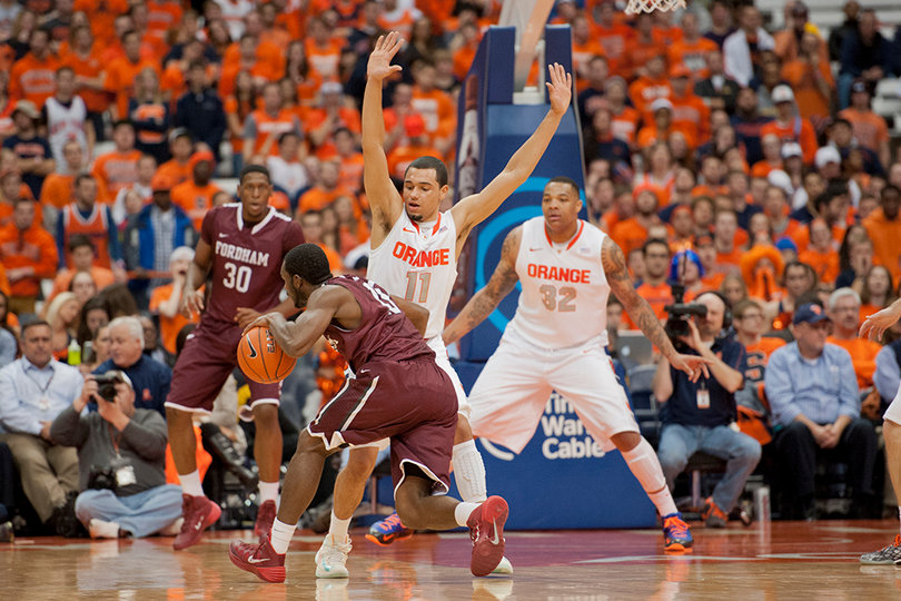 Tyler Ennis and DaJuan Coleman slide to defend a driving Rams guard.