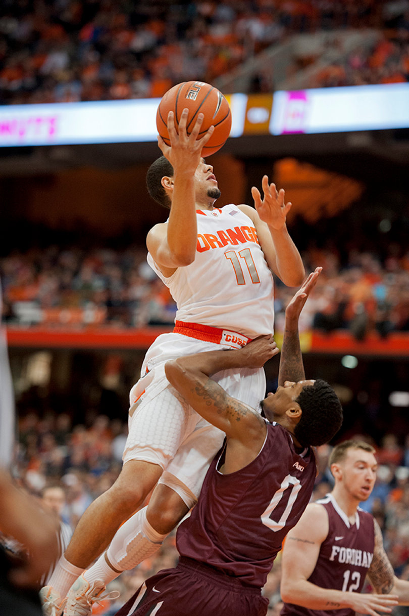 Tyler Ennis rises to the rim over Fordham guard Branden Frazier. Ennis finished with 16 points.