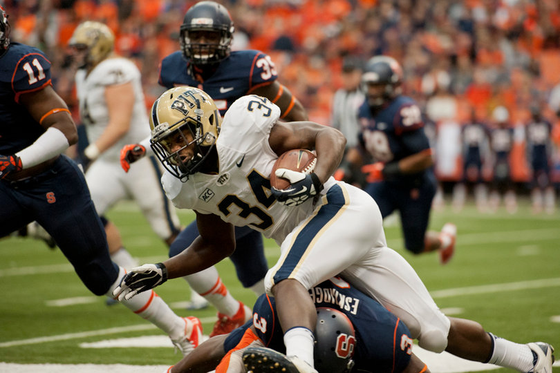 Eskridge and the Orange's defense trip up Panther running back Isaac Bennet as he tries to break a run.