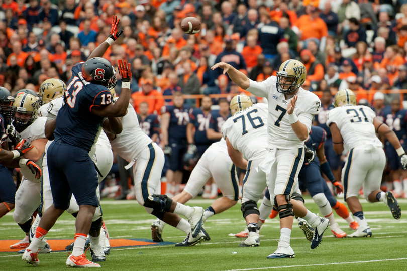 Pitt quarterback Tom Savage lofts a pass over defensive end Ron Thompson and the SU line.