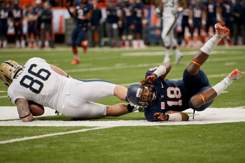 Syracuse defensive back Darius Kelly knocks Pittsburgh tight end J.P. Holtz down after a catch.