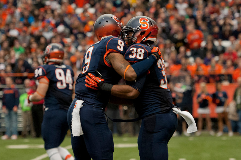 Lynch and Orange cornerback Ri'Shard Anderson embrace.