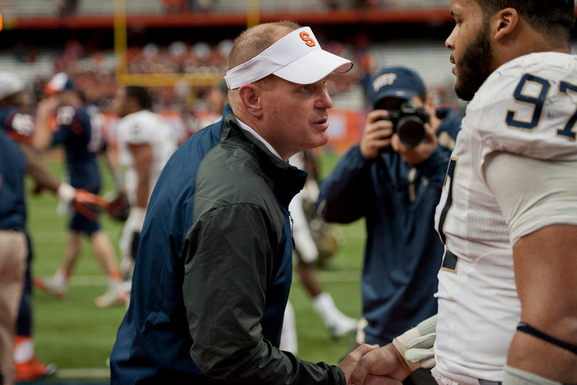 Orange head coach Scott Shafer congratulates Pitt defensive tackle Aaron Donald, who blocked an extra point.