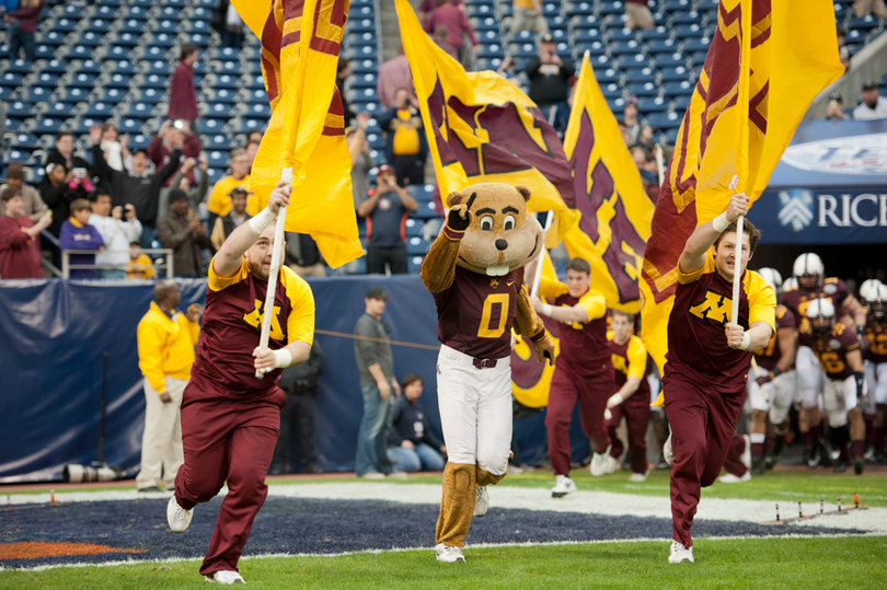 Goldy Gopher leads the Gophers out of the tunnel.
