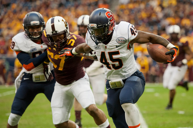 Jerome Smith stiff arms a defender while bouncing outside. 
