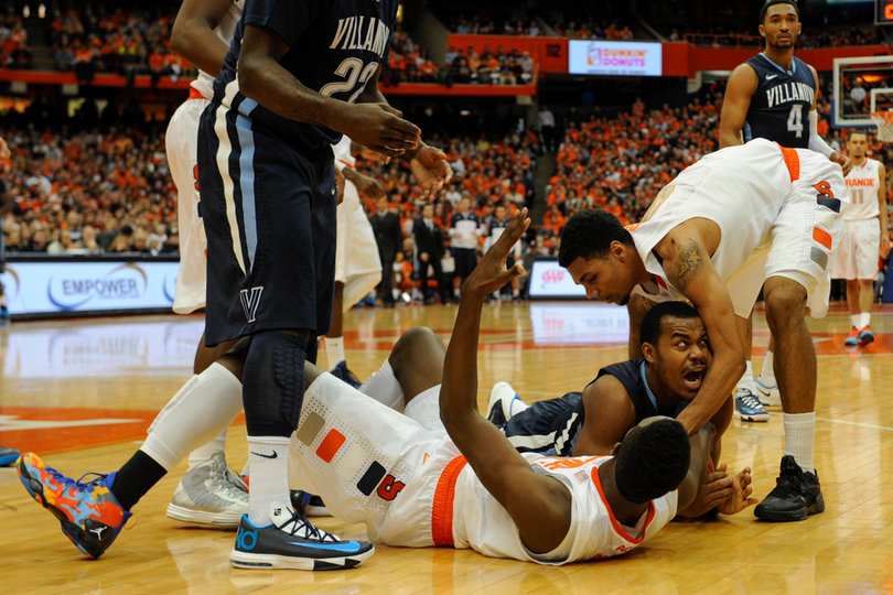 Michael Gbinije tries to help up Grant after a play.