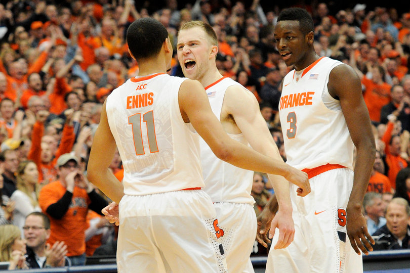 Trevor Cooney celebrates with Ennis and Grant during Syracuse's late first half run.