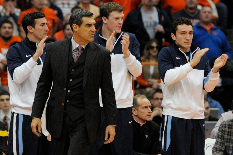 Wildcats head coach Jay Wright scours at the court. 