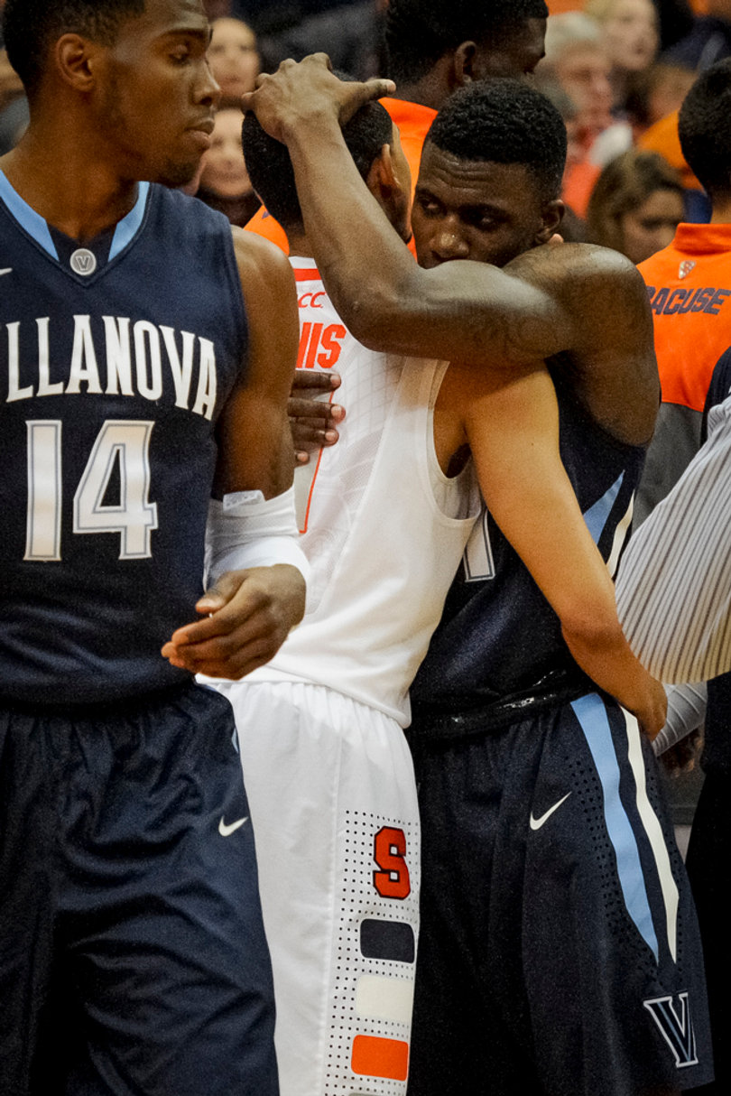 Brothers Dylan (right) and Tyler Ennis embrace following their first collegiate game against each other. 