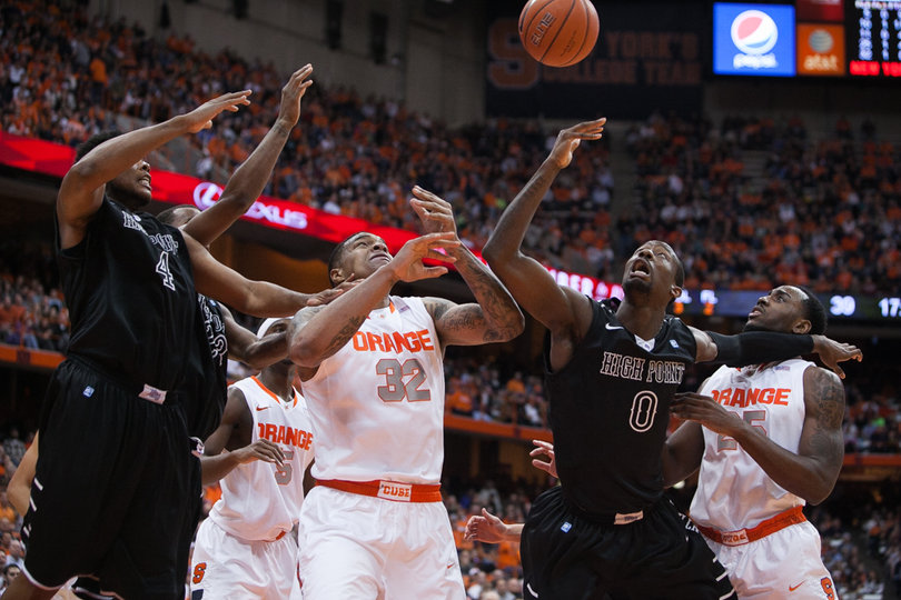 Syracuse and High Point attempt to grab a rebound in the paint. 