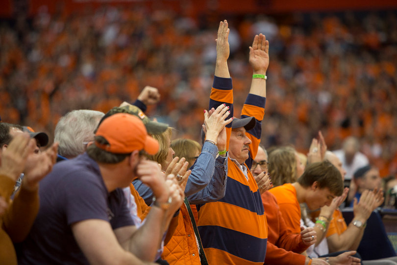 A Syracuse fan celebrates a Syracuse 3-pointer. Despite the inclement weather a large, loud crowd showed up to the Carrier Dome. 