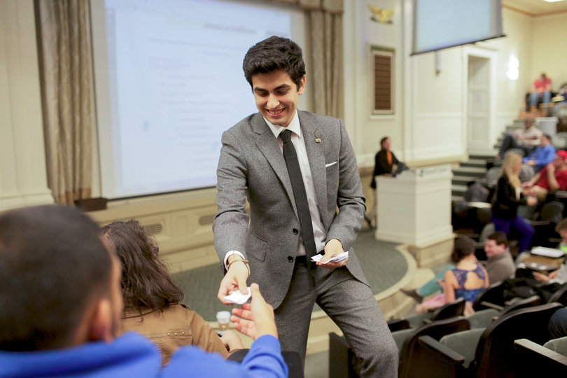 Boris Gresely hands out ballots to members of the assembly during the first SA meeting at Maxwell Auditorium Monday. The assembly confirmed cabinet appointees and elected a speaker, parliamentarian and recorder.