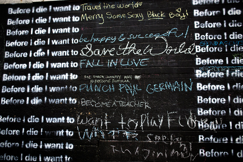 Some of the bucket list items on the wall include “fall in love,” “save the world,” and “become a teacher.” 