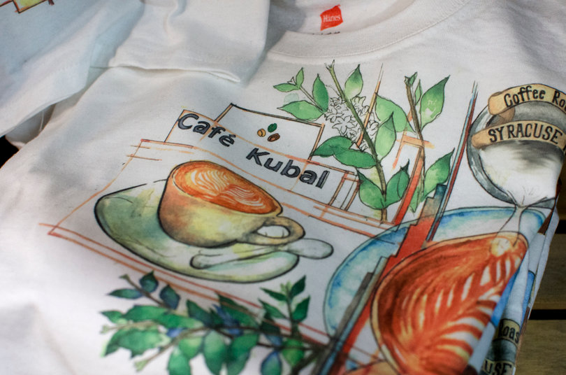 The T-shirts designed by Root Goods for Cafe Kubal are on sale for $12 each. Matt Godard, Cafe Kubal's owner, ordered 100 of the shirts from Root Goods.