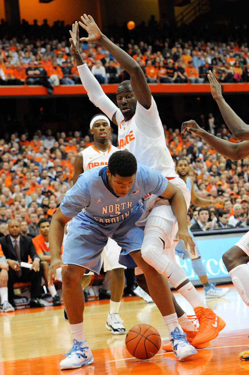 Keita traps a player under the basket.