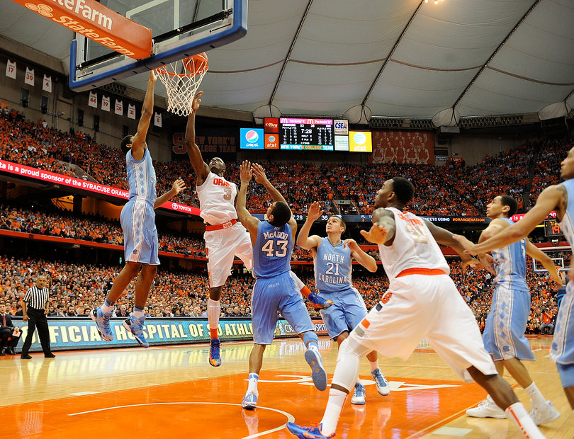 Grant goes for a shot in a crowd of Tar Heels. 