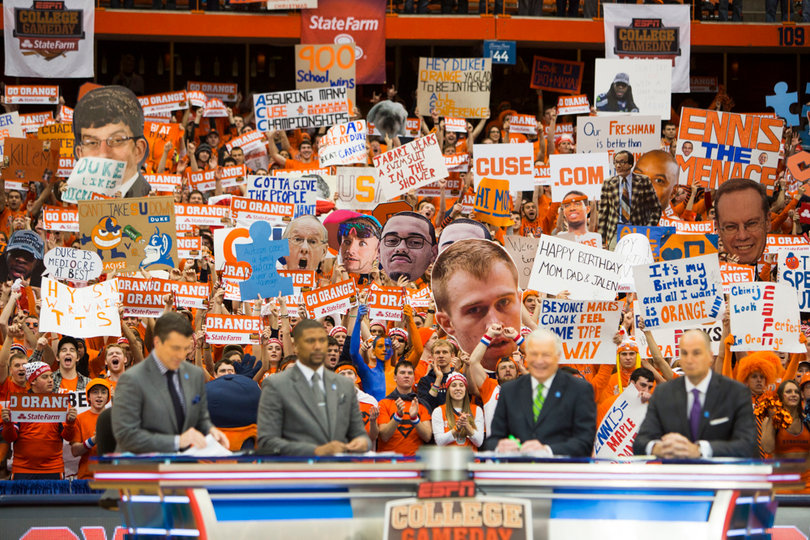 From left: Rece Davis, Jalen Rose, Digger Phelps and Bilas discuss the upcoming game with a sea of signs behind them. 