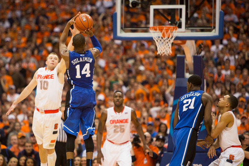 Sulaimon shoots a 3-pointer over Cooney's outstretched arm.
