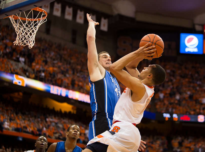 Ennis is fouled while attempting a shot over Marshall Plumlee.