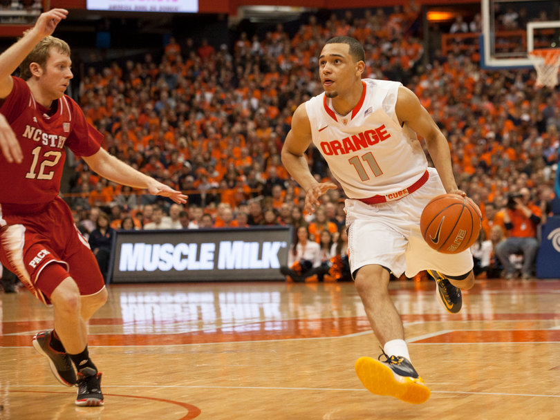 Ennis drives toward the paint while N.C. State point guard Tyler Lewis tries to obstruct his path. 