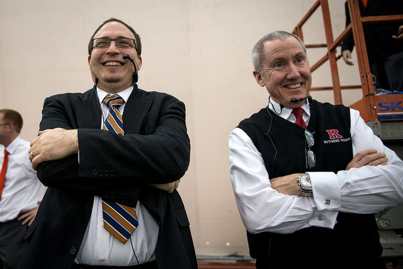 Justin Mertz, left, and Rutgers veteran director of athletic bands Timothy Smith grin as they listen to their bands performing together for the first time on Sunday morning.
