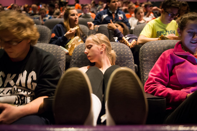 Casey Alterio takes a nap in a movie theater in an undisclosed location somewhere between the Rutgers' practice field and MetLife Stadium on Sunday afternoon. The Marching Band was taken to the movie theater to receive their Super Bowl credentials and to wait for their police escort.