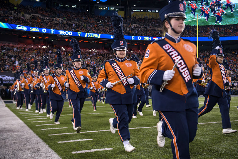 SUMB members sprint onto the field at MetLife Stadium on Sunday evening. They accompanied the Rutgers Marching Band for the Super Bowl pregame show.