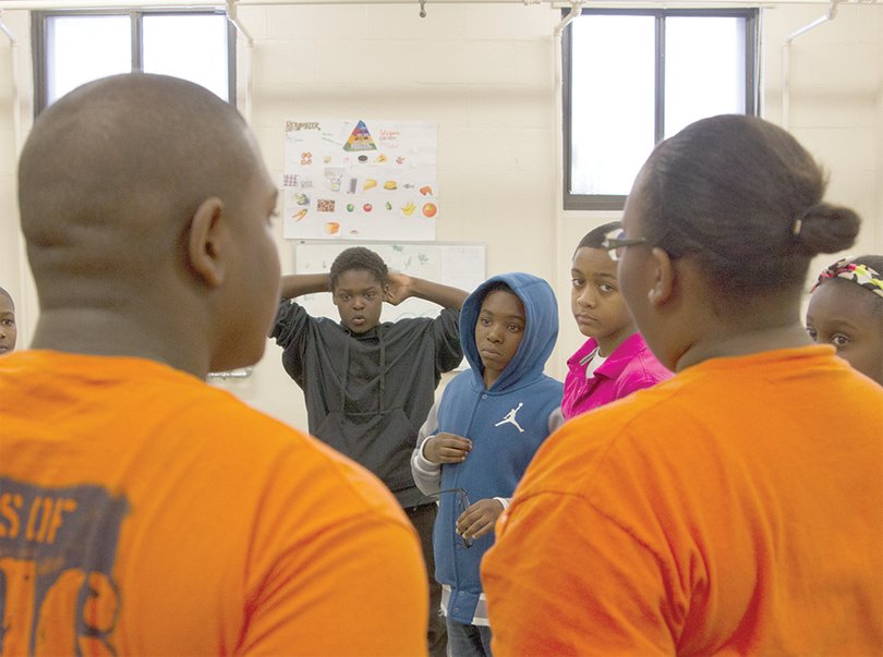 Syracuse University student volunteers meet with children at Wilson Park Community Center.