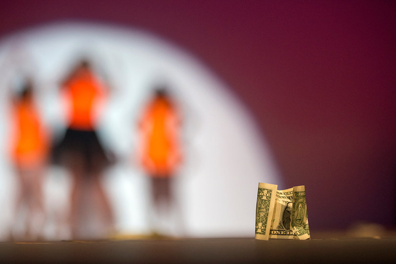 A dollar bill remains on the stage as Tanya Tatone performs her jail-themed routine at the Totally Fabulous Drag Show. 