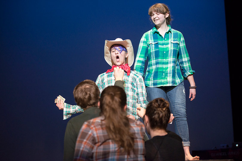 Audience members line up at the edge of the catwalk to tip drag king George Michael during his performance of Kenny Chesney's "She Thinks My Tractor's Sexy."
