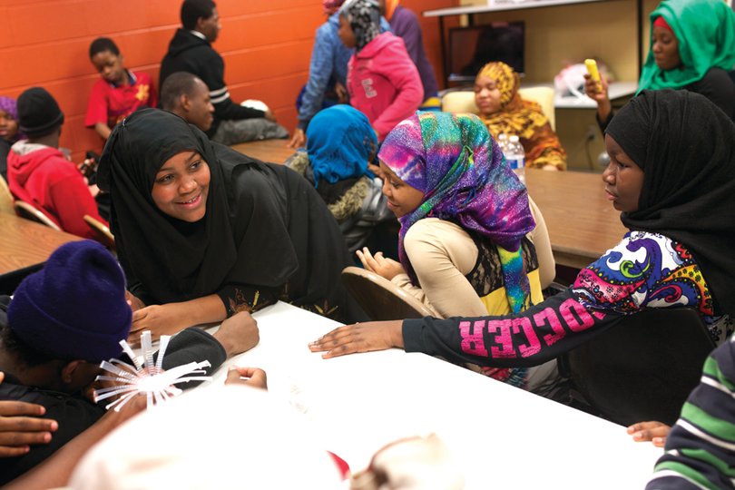 Mariamo Mukoma talks with friends at the after school program for refugee students located in the community center on South Avenue. 
