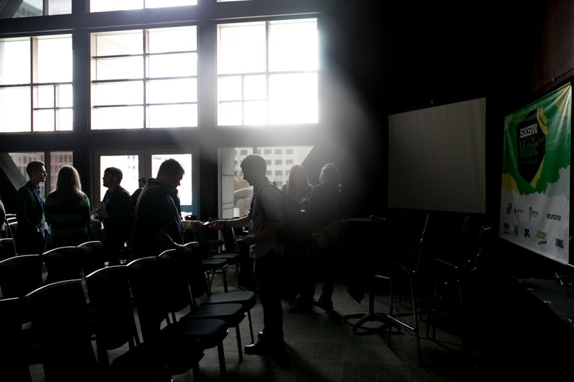 Participants exchange business cards at the "College Buyers/College Radio Peer Meet Up" hosted by Kelly Benini, University Union director of concerts. The meetup provided an opportunity to exchange ideas and suggestions on issues related to college event planning and promotions.