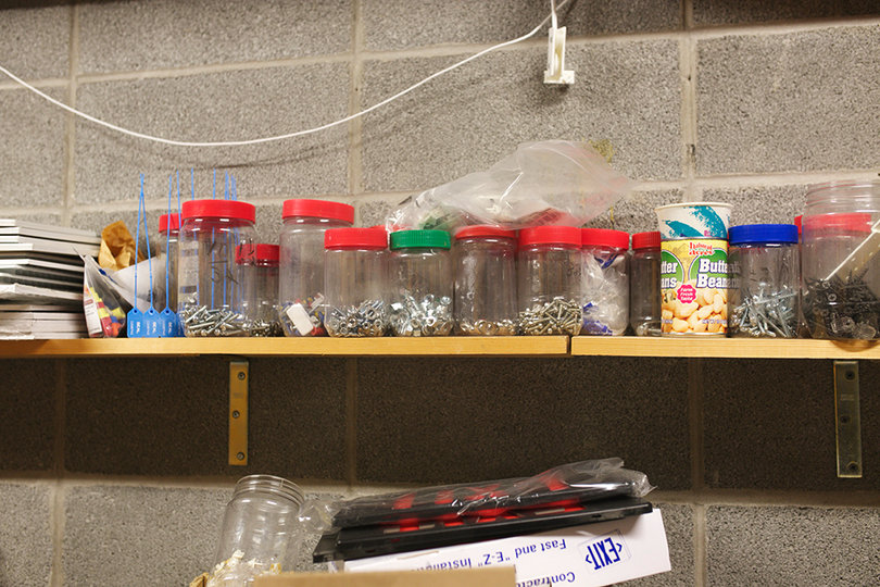 Reeder’s office is lined with Jiffy peanut butter jars repurposed as organizational containers. He also recycles other containers for storage in his Day Hall office.