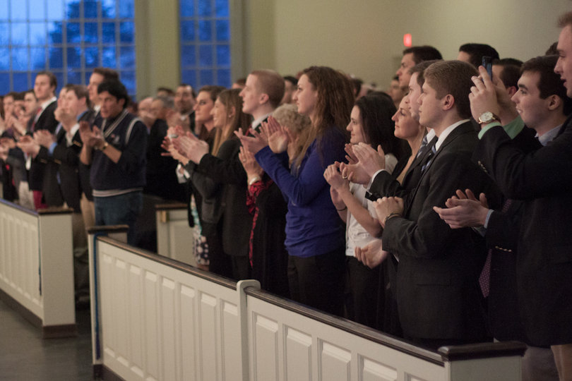 Audience members applaud former Congressman Ron Paul during his appearance at Hendricks Chapel Wednesday night. SU's College Republicans arranged the event.