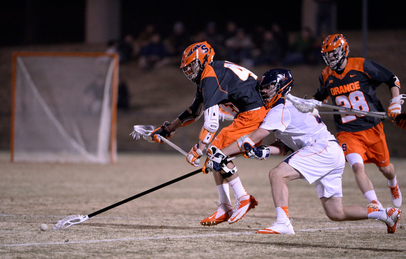 Syracuse and Virginia fight for a ground ball in the midfield. 