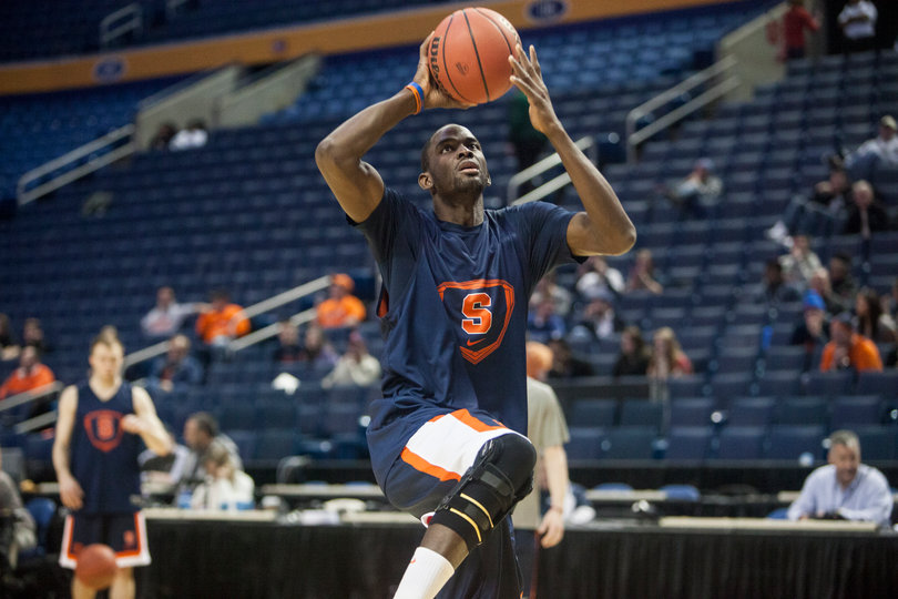Senior center Baye Moussa Keita warms up. He's worn the brace on his right knee since returning from a right knee sprain about a month ago.
