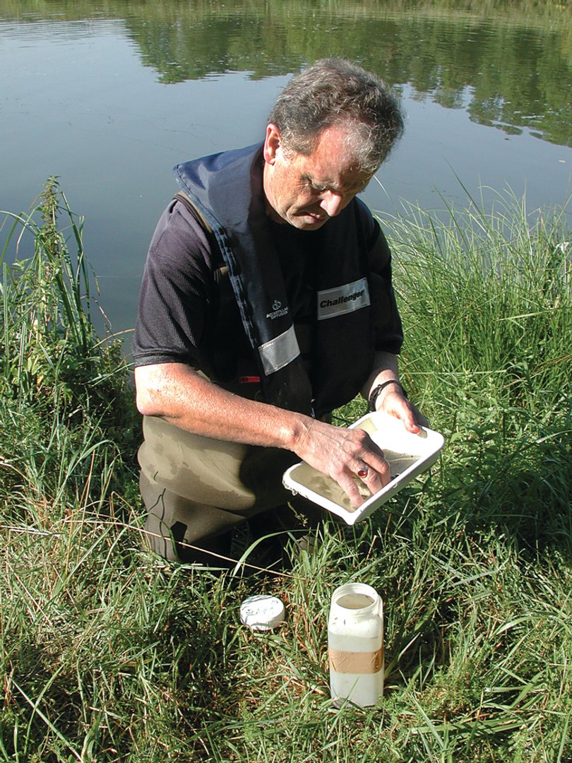 Molloy samples zebra mussels from a river in France.