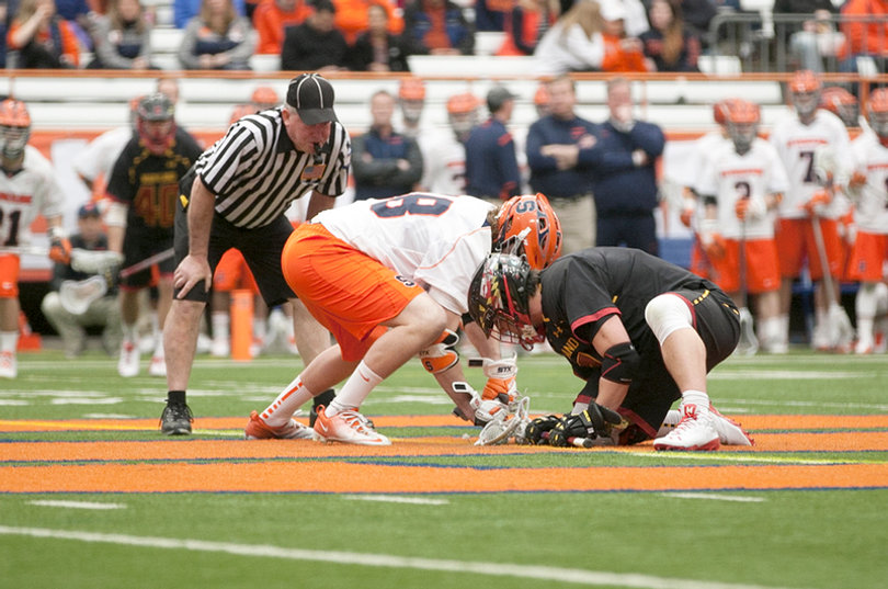 Maryland's Charlie Raffa (right) listens to differently timed whistle counts as an off-field drill, and his faceoff percentage of 64 is good for seventh in the nation this season. 