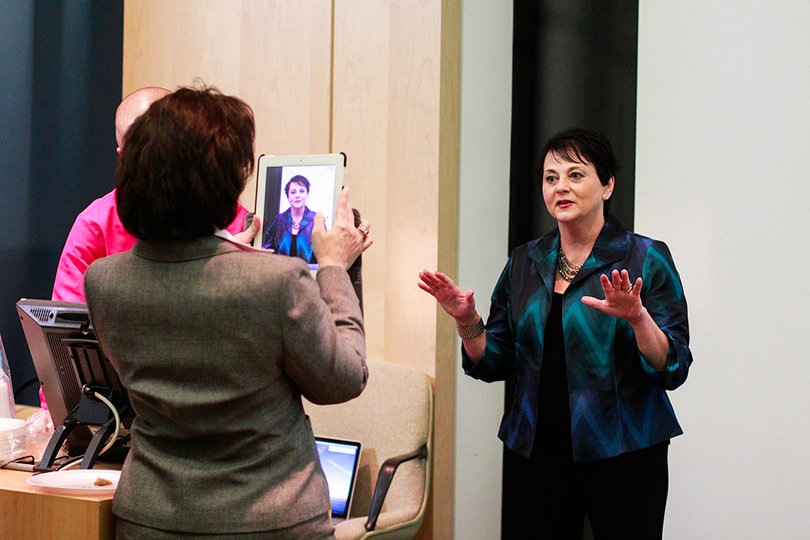 Yvonne Conte, a respected motivational keynote speaker, is recorded on an iPad while receiving speech coaching. 