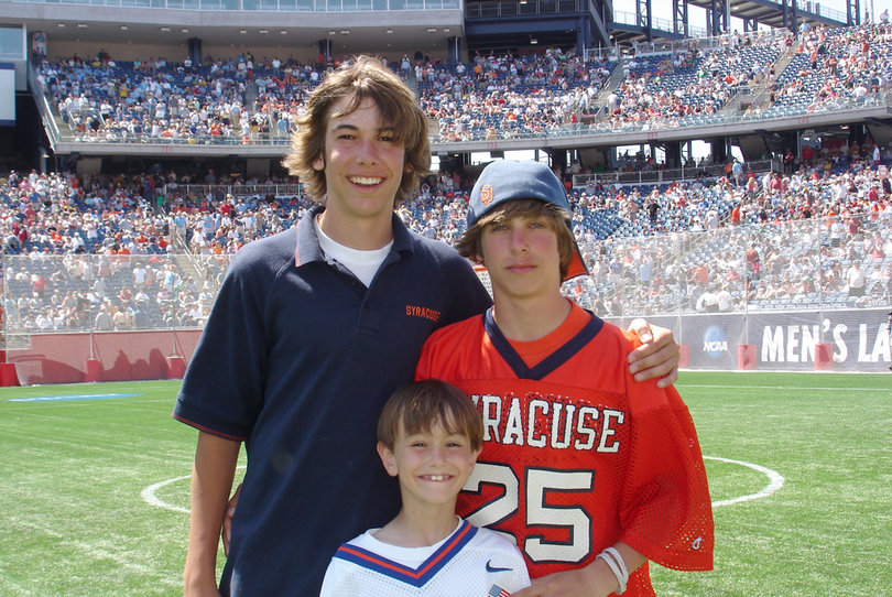 Derek (left), Dylan (right) and younger brother Danny (bottom) at Gillette Stadium in 2008, where their dad, Derek Maltz Sr., was honored with his teammates for Syracuse's first national championship in 1983. 