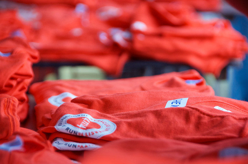 Free t-shirts given out to run participants lay on a table in the quad on April 11, 2014.