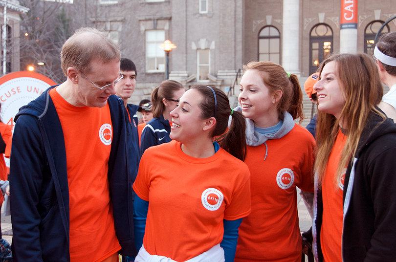Chancellor Kent Syverud interacts with seniors Julianne Peixoto, Emmie Martin, and Rebecca McGraw in the quad on April 11, 2014.