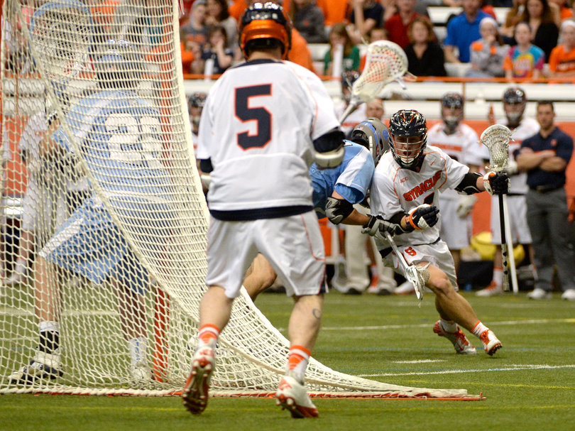 Nicky Galasso looks to take a pass behind the North Carolina  net. 