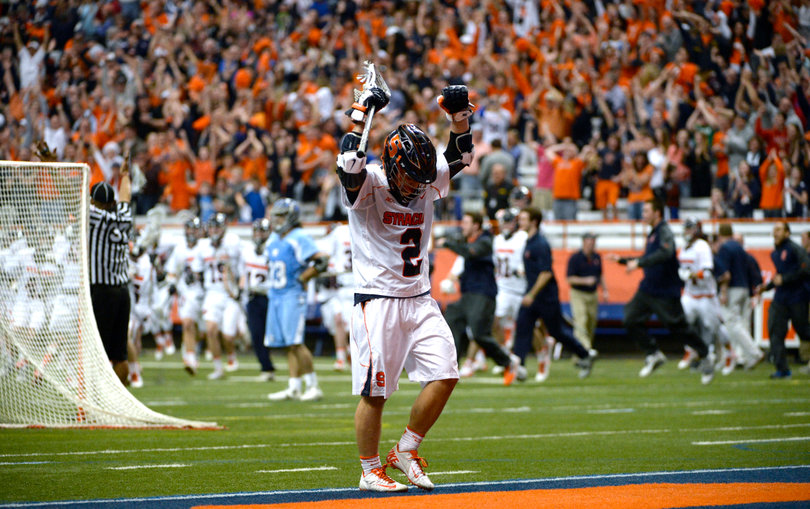 Rice lifts his arms up after Syracuse scores its final, game-winning goal in double overtime. 