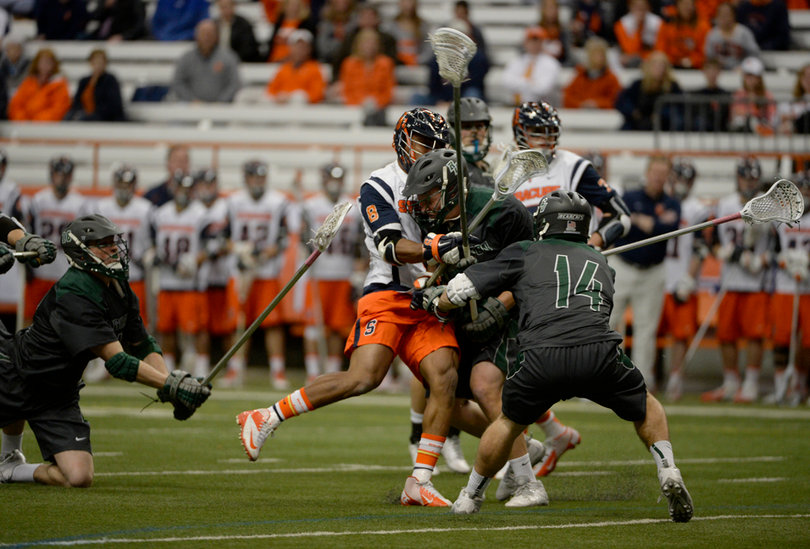 A Syracuse and Binghamton player collide in a crowd of players. 